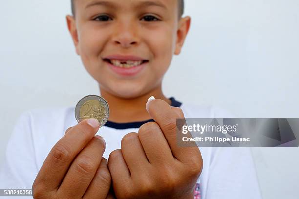 7-year-old boy showing a lost tooth and coin - tooth fairy stock pictures, royalty-free photos & images