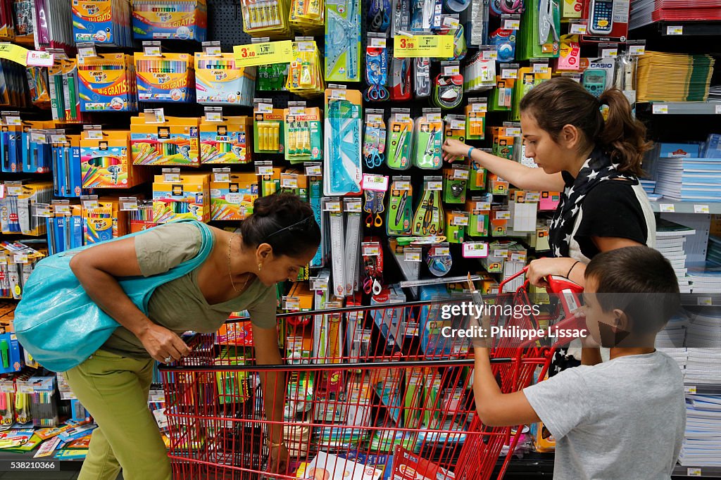 Family shopping for school supplies in a supermarket