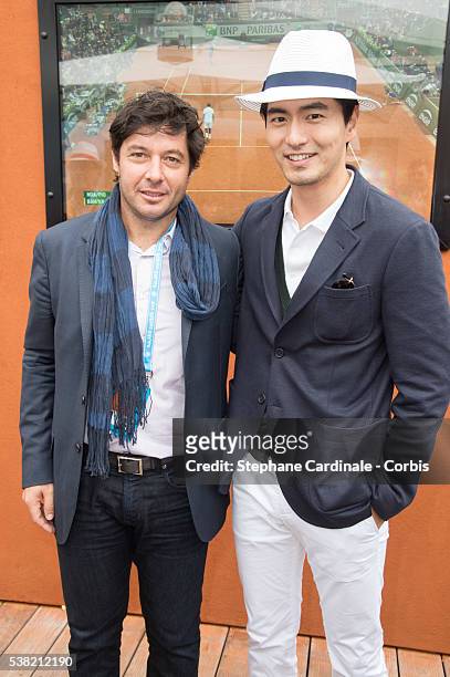 Tennis player Sebastien Grosjean and South Korean actor Lee Jin-Wook attends day Fourteen of the 2016 French Open at Roland Garros on June 4, 2016 in...