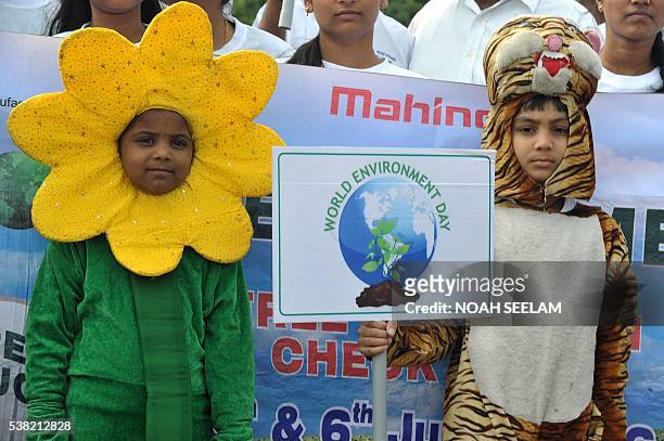 Indian students dressed up in costumes carry placards during a rally on World Environment Day in Hyderabad on June 5, 2016. World Environment Day is...
