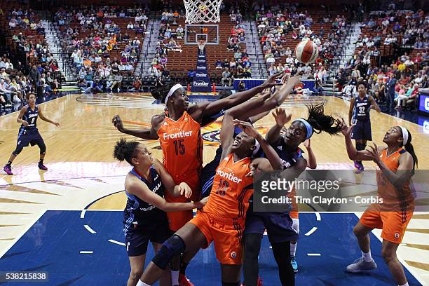 Aneika Henry-Morello and Chiney Ogwumike of the Connecticut Sun challenge for a rebound with Matee Ajavon and Rachel Hollivay of the Atlanta Dream...