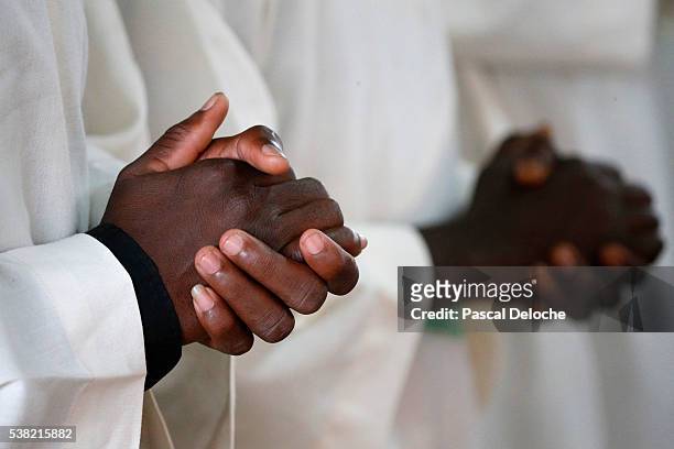 african priests praying. joined hands. - priest stockfoto's en -beelden