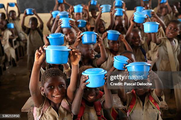 food distribution in an african primary school. - togo stockfoto's en -beelden