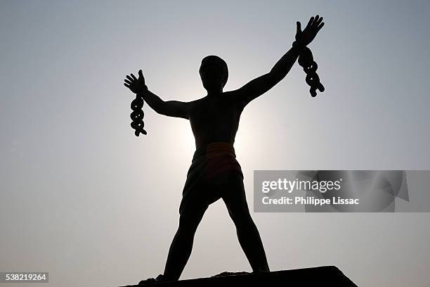statue depicting a slave breaking his chains - slaves in chains imagens e fotografias de stock