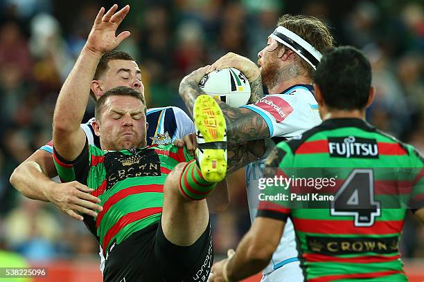 Nathan Brown of the Rabbitohs and Chris McQueen of the Titans contest for the ball during the round 13 NRL match between the South Sydney Rabbitohs...