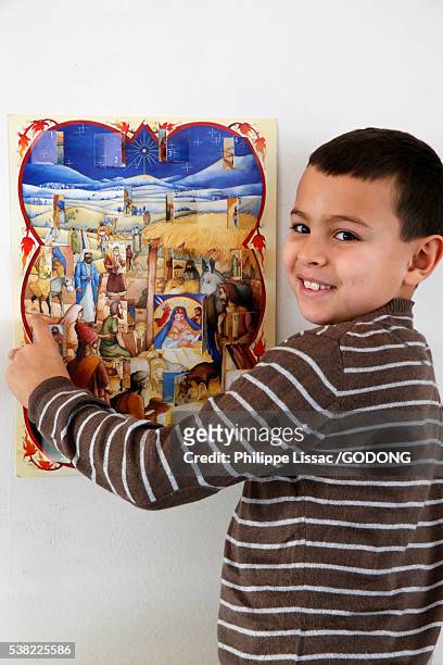 8-year-old boy with an advent calendar - child with advent calendar stock pictures, royalty-free photos & images
