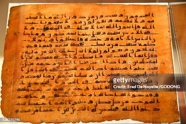 institut du monde arabe. arab world institute. exhibition : hajj, islamic pilgrimage to mecca. quran page. califat abbâsside, end of the viiith century. kufic writing. - hajj 2014 stock pictures, royalty-free photos & images