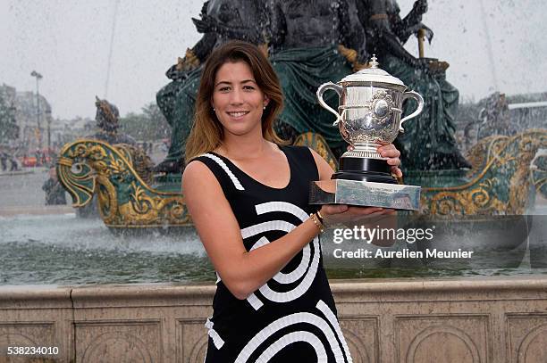 Garbine Muguruza of Spain poses with La Coupe Suzanne Lenglen after winning the women's final at the French Open at Place de la Concorde on June 5,...