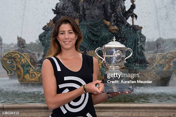 Garbine Muguruza of Spain poses with La Coupe Suzanne Lenglen after winning the women's final at the French Open at Place de la Concorde on June 5,...