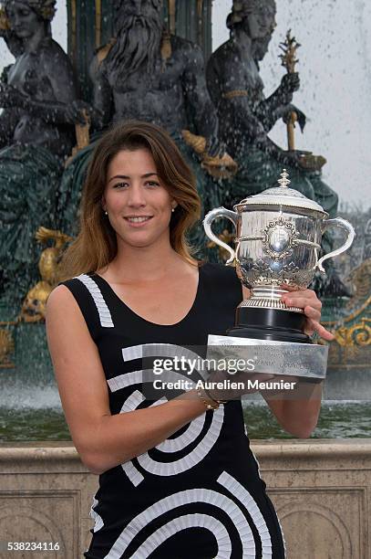 Garbine Muguruza of Spain poses with La Coupe Suzanne Lenglen after winning the women's final at the French Open at Place de la Concorde on June 5,...