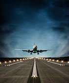 Passenger airplane landing at dusk
