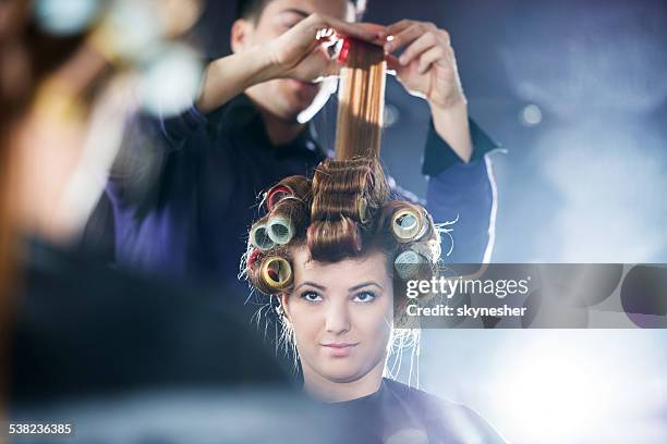 putting curlers at the hair salon. - hair rollers stock pictures, royalty-free photos & images
