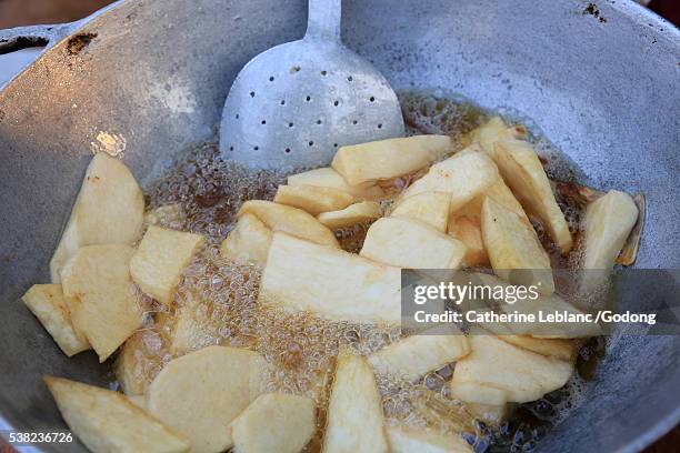 cooking cassava in oil. cassava chips. - lome stock pictures, royalty-free photos & images