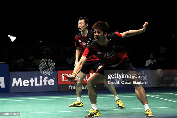 Lee Yong Dae and Yoo Yeon Seong of South Korea plays a shot during the 2016 Indonesia Open final match in man double against Chai Biao and Hong Wei...