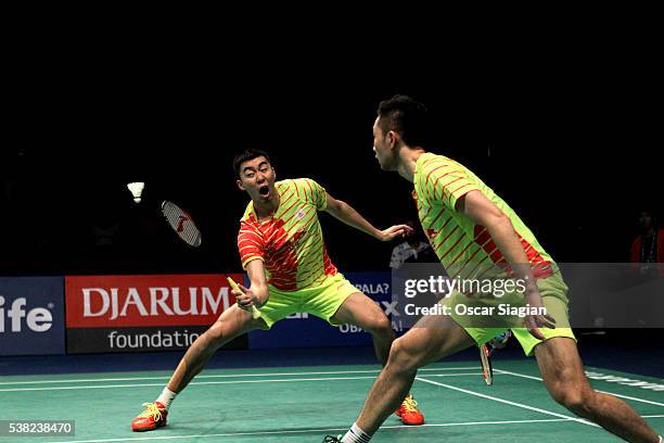 Chai Biao and Hong Wei of China plays a shot during the 2016 Indonesia Open final match in man double against Lee Yong Dae and Yoo Yeon Seong of...