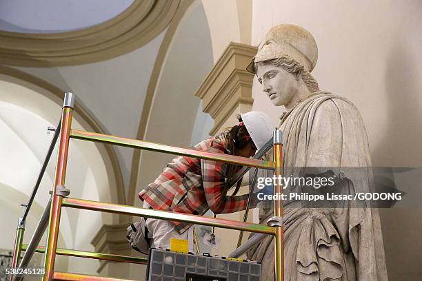 student of the brera fine art academy restoring a statue, milan. - fine art statue stock-fotos und bilder