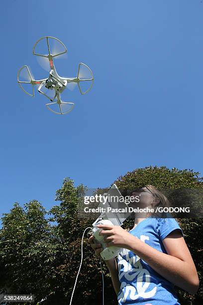 girl flying a drone loaded with a video camera. - quadcopter stock pictures, royalty-free photos & images
