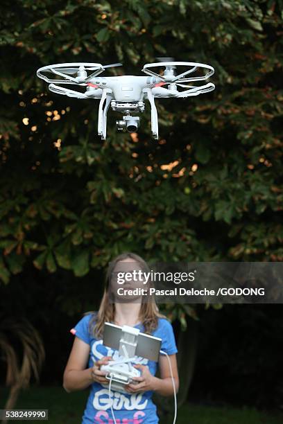 girl flying a drone loaded with a video camera. - quadcopter stock pictures, royalty-free photos & images
