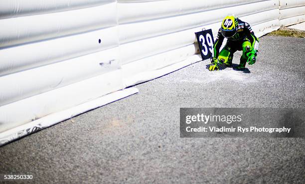 Pol Espargaro of Spain and Monster Yamaha Tech 3 leaves a sign with number to honour Moto 2 rider Luis Salom of Spain and SAG Team who died after...