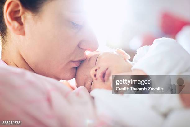 mother with her newborn son - thanasis zovoilis stock pictures, royalty-free photos & images