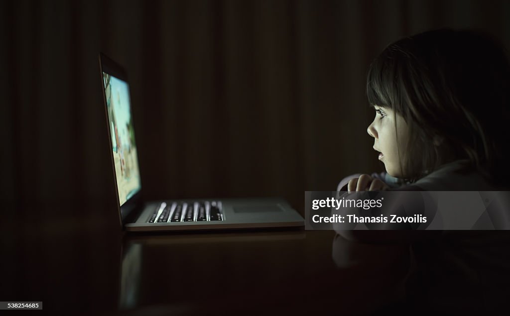 Small girl using a laptop