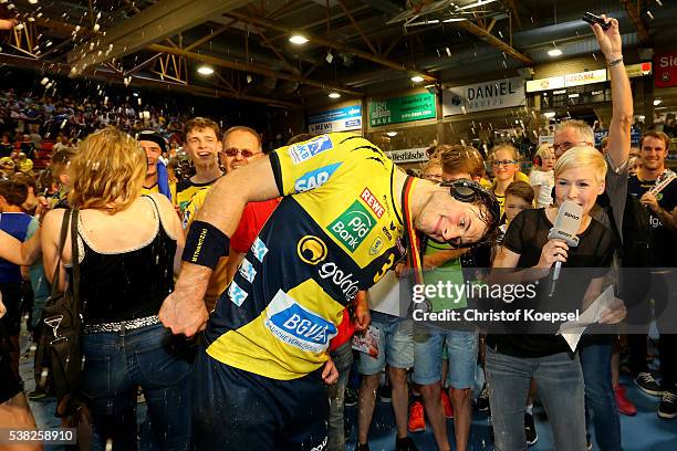 Uwe Gensheimer of RN Loewen iss poured with beer during an interview with Anett Sattler of SPORT 1 after winning the German Championships after the...