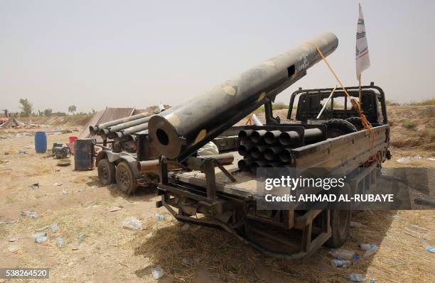 Truck mounted with a home-made rocket launcher is parked on the front line as Iraqi pro-government forces hold a position near the village of...