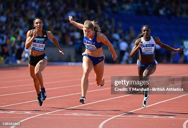 Dafne Schippers of Netherlands runs in the Final of the Women's 100m flanked by Ashleigh Nelson and Dina Asher-Smith of Great Britain during the...