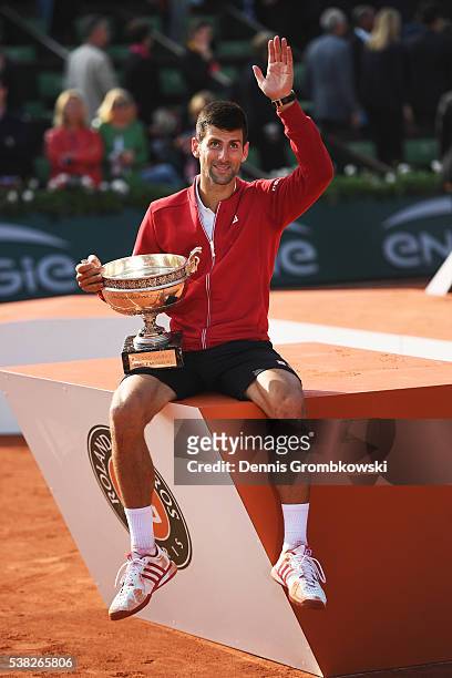 Champion Novak Djokovic of Serbia poses with the trophy following his victory during the Men's Singles final match against Andy Murray of Great...
