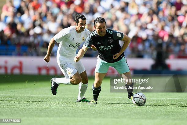 Marc Overmars of Ajex Legends is challenged by Luis Figo of Real Madrid Leyendas during the Corazon Classic charity match between Real Madrid...