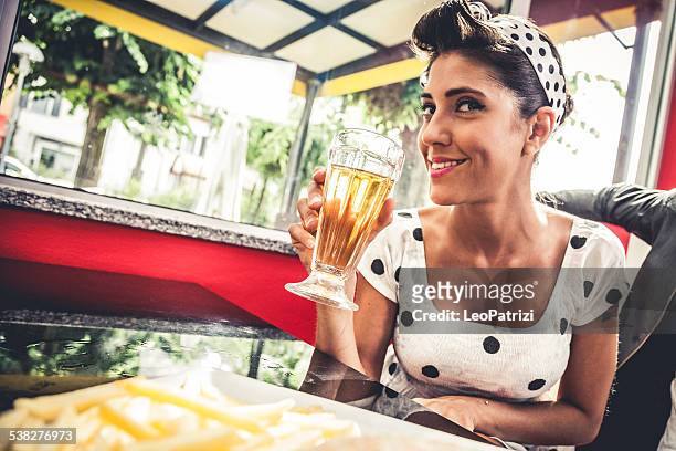 mujer bebiendo una cerveza fría con amigos - rockabilly fotografías e imágenes de stock