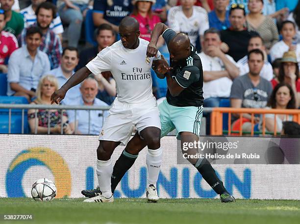 Clarence Seedorf of Real Madrid Legends and George Finidi of Ajax AFC Legends compete for the ball during the Corazon Classic charity match between...