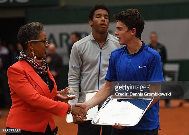 Geoffrey Blancaneaux of France receives the trophy following his victory during the Boys Singles final match against Felix Auger Aliassime of Canada...