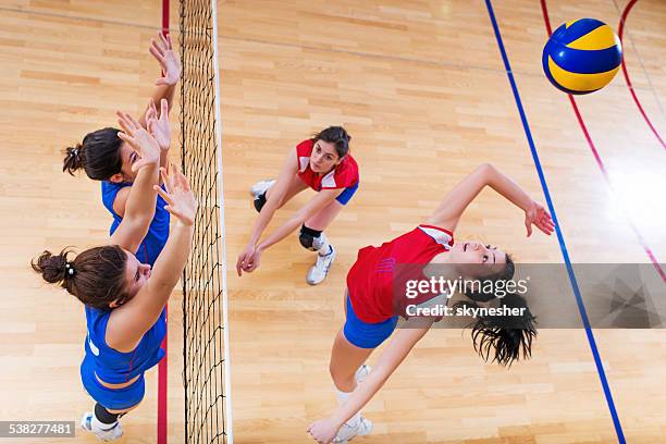 volleyball block action on the net. - girls volleyball stock pictures, royalty-free photos & images