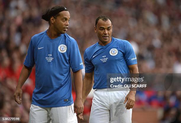 Former Brazilian footballers Ronaldinho and Cafu take part in the Soccer Aid charity football match between England and the Rest of the World at Old...