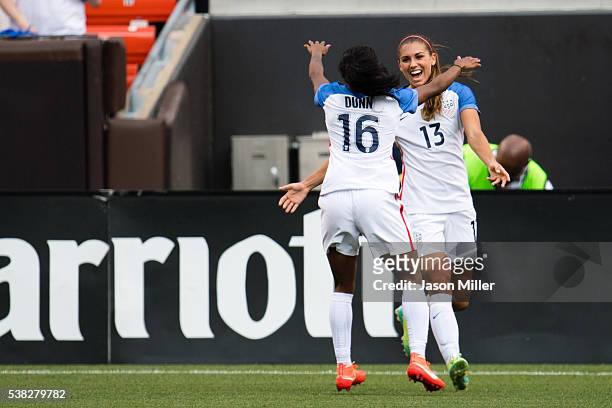Crystal Dunn celebrates with Alex Morgan after Morgan of the U.S. Women's National Team scored with an assist by Dunn during the second half of a...