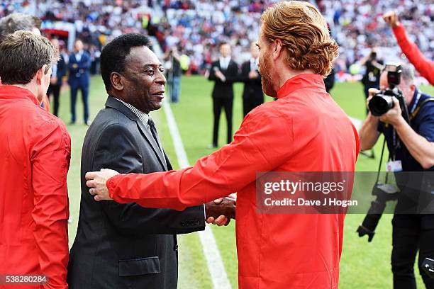 Damien Lewis greets Pele during Soccer Aid at Old Trafford on June 5, 2016 in Manchester, England.