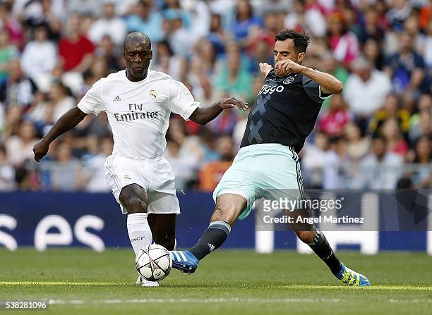 Clarence Seedorf of Real Madrid Legends competes for the ball with Kenneth Perez of Ajax Legends during the Corazon Classic charity match between...