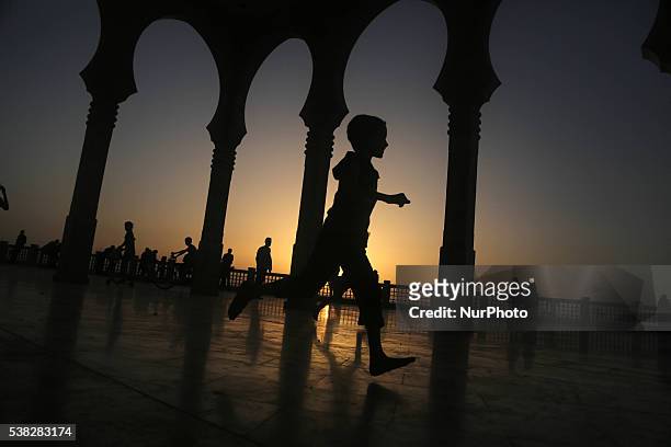 Palestinian walks Al Khalde mosque during sunset in the west of Jabaliya during the Muslim holy month Ramadan, in the Gaza town of Jabaliya, on June...