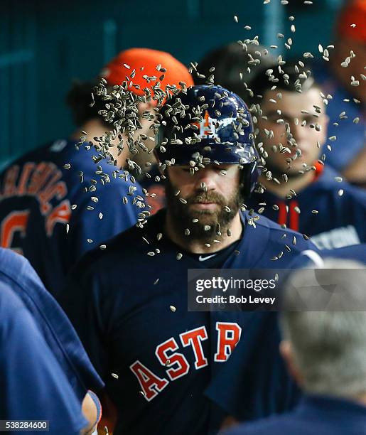 Evan Gattis of the Houston Astros receives a face full of sunflower seeds after hitting a home run in the sixth inning against the Oakland Athletics...