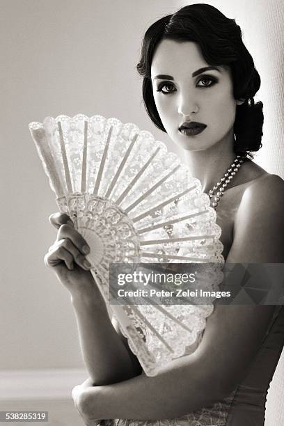 beautiful retro woman with fan - fashion glamour pearl stock pictures, royalty-free photos & images