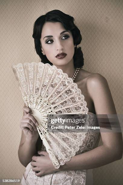 retro woman with lace fan - vintage corset stock-fotos und bilder