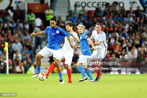 Louis Tomlinson and Niall Horanat play during Soccer Aid at Old Trafford on June 5, 2016 in Manchester, England.