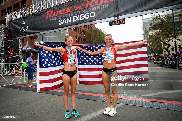 Time Olympian Shalane Flanagan, right, and 2-time Olympian Amy Cragg, left, pose with the Stars and Stripes flag after both set personal best times...