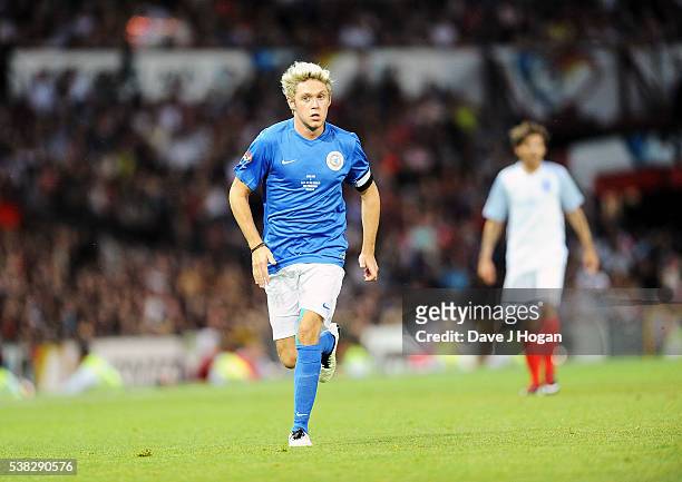 Louis Tomlinson and Niall Horanat play during Soccer Aid at Old Trafford on June 5, 2016 in Manchester, England.