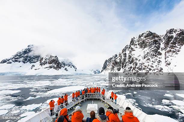 a cruise ship approaches the lemaire channel - antarctica boat stock pictures, royalty-free photos & images