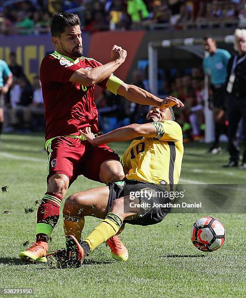 Tomas Rincon of Venezuela collides with Jobi McAnuff of Jamaica during a match in the 2016 Copa America Centenario at Soldier Field on June 5, 2016...