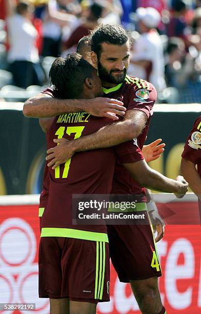 Josef Martinez of Venezuela celebrates with Oswaldo Vizcarrondo of Venezuela after he scores a goal in the first half during a group C match between...