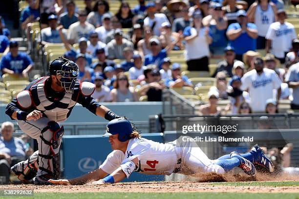 Enrique Hernandez of the Los Angeles Dodgers is out at home plate in the fifth inning against A.J. Pierzynski of the Atlanta Braves at Dodger Stadium...