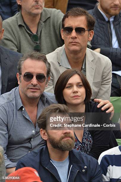 Actor Clive Owen, actor Jean Dujardin, Nathalie Pechalat and actor Clovis Cornillac attend the French Tennis Open Day Fifteen with the Final between...